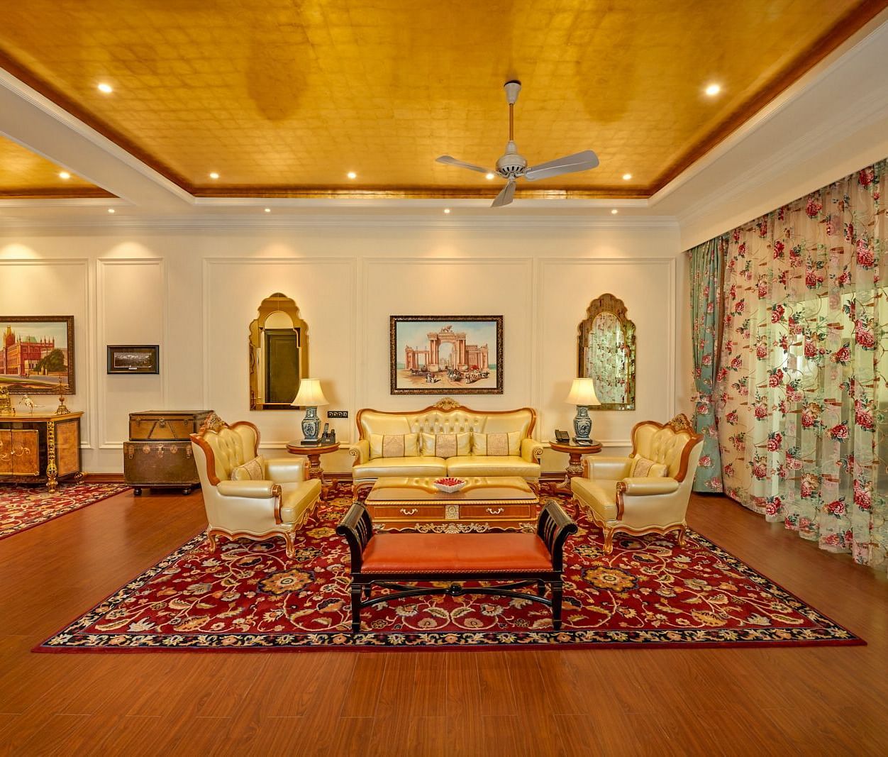 Luxurious Colonial  Room with elegant seating, chandelier lighting, and traditional decor.