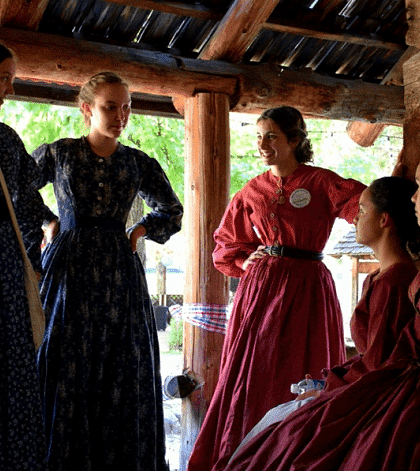 Women talking to each other in a wooden cabin - Narrow Gauge Inn - A Serenite Hotel Near Fish Camp.