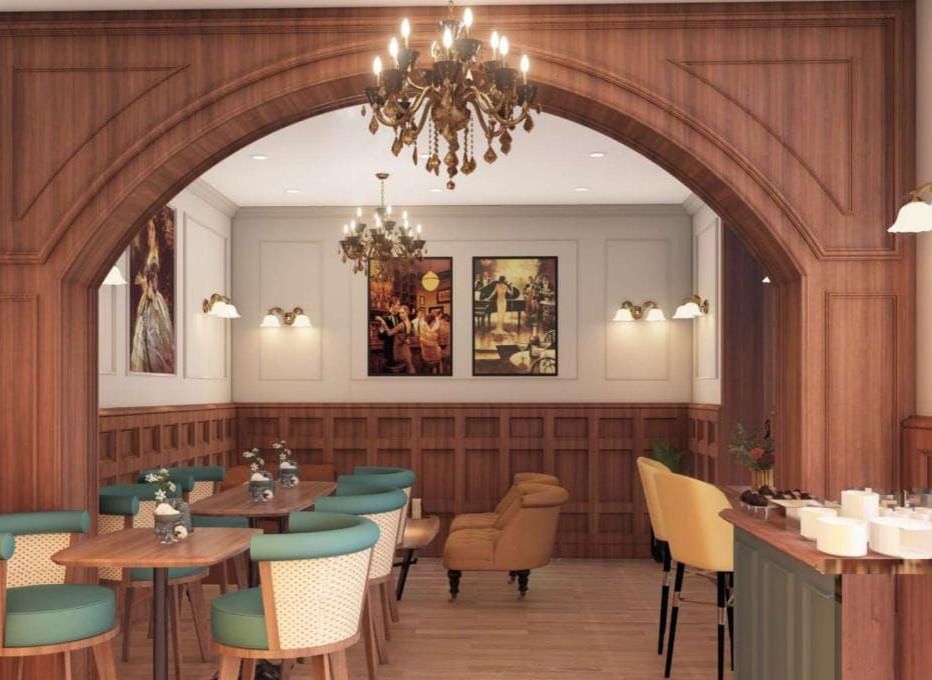 Elegant restaurant or hotel dining area featuring dark wood panelling, an arched doorway, and teal and mustard seating at BluSalzz Terrah Hills Resort, Dalhousie.