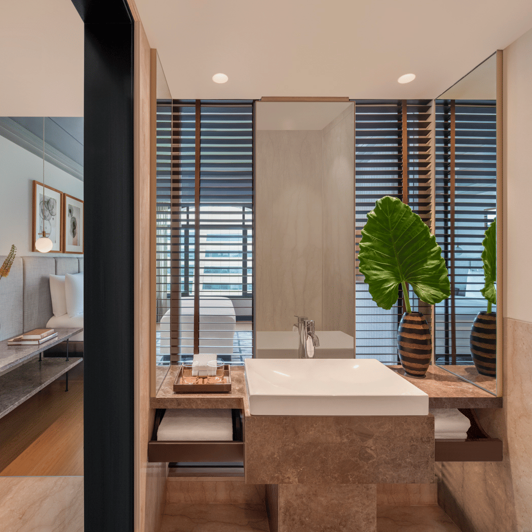 Bathroom with shower area, sink, and wall mirror at The Raintree, St. Mary’s Road.