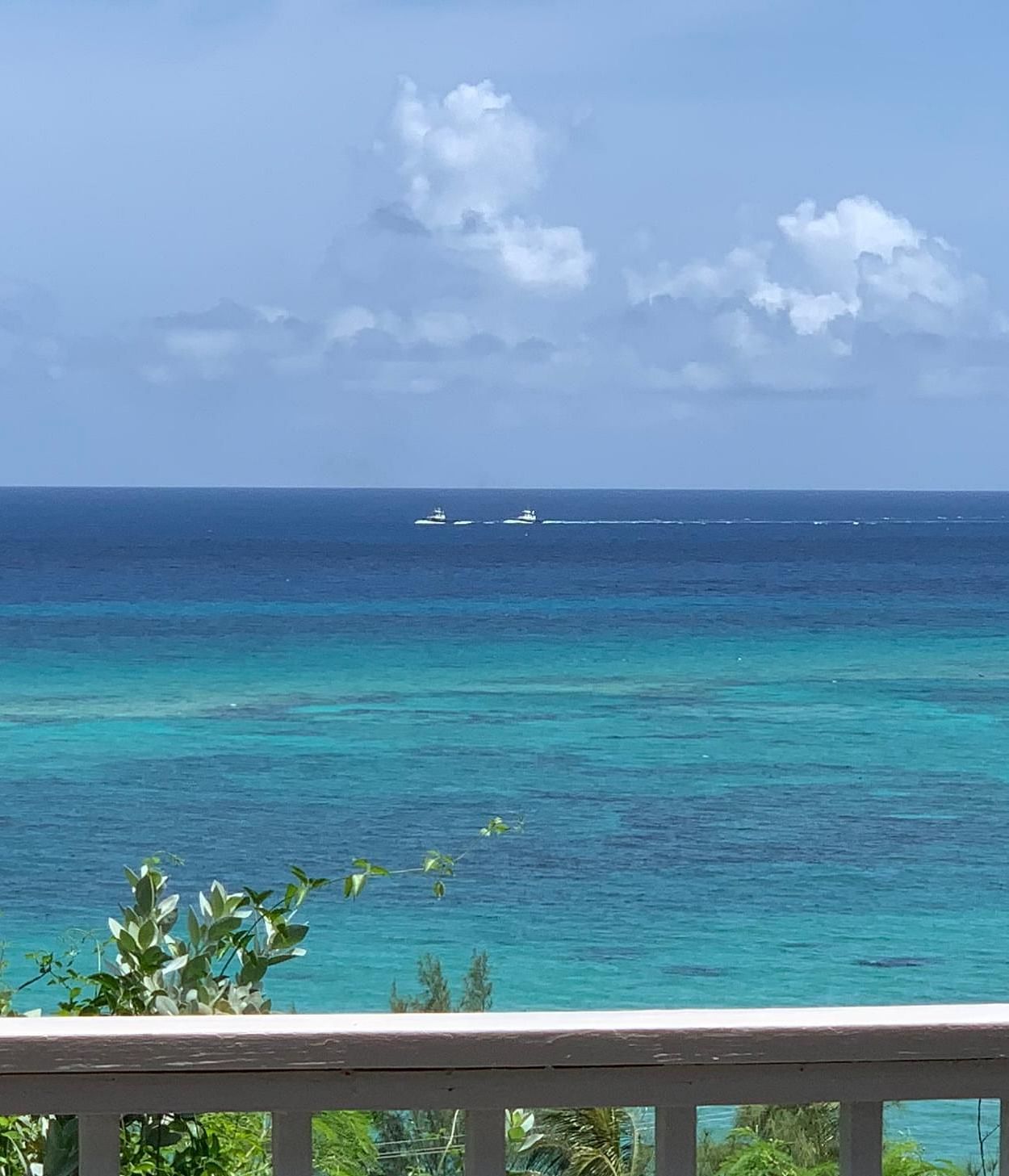 View of an ocean beyond a wooden balcony railing | A Stone's Throw Away
