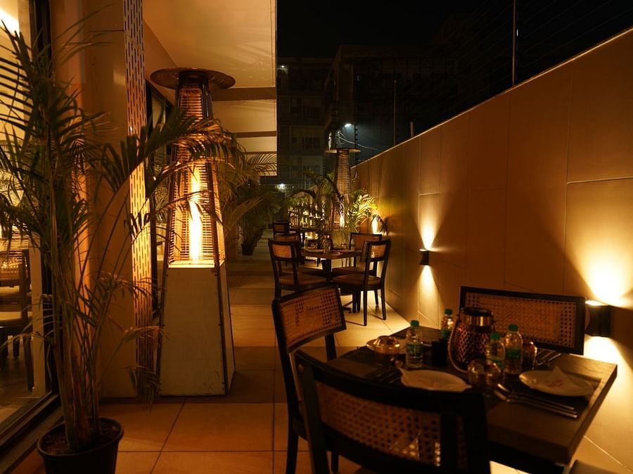 outdoor seating area of Mishri restaurant at Triptam Hotel, Vrindavan
