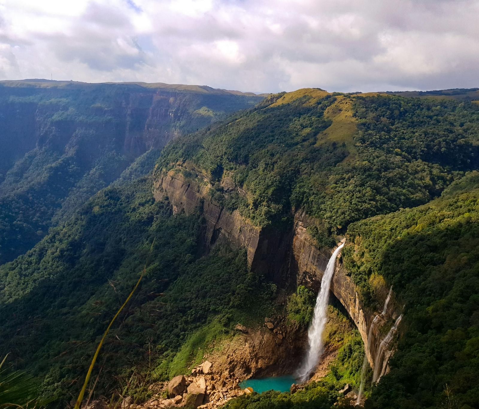 A breathtaking valley view with waterfalls cascading from cliffs.