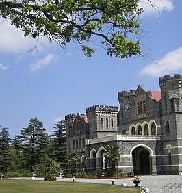 An image of a castle type building surrounded by trees