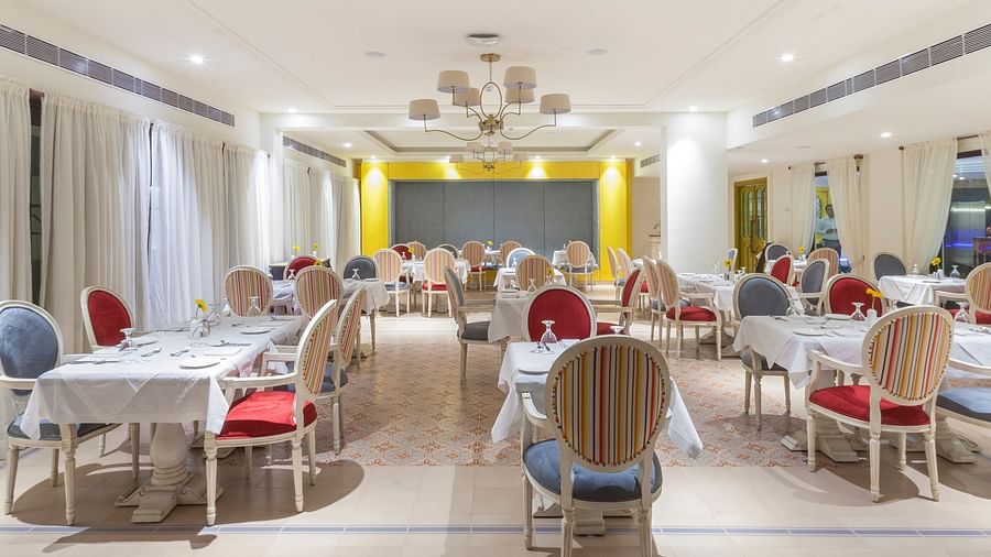 Fine dining area with numerous chairs and tables set and ready for guests.