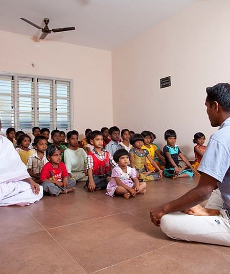 People sitting on the floor in a room, indoor setting - Shreyas Retreat