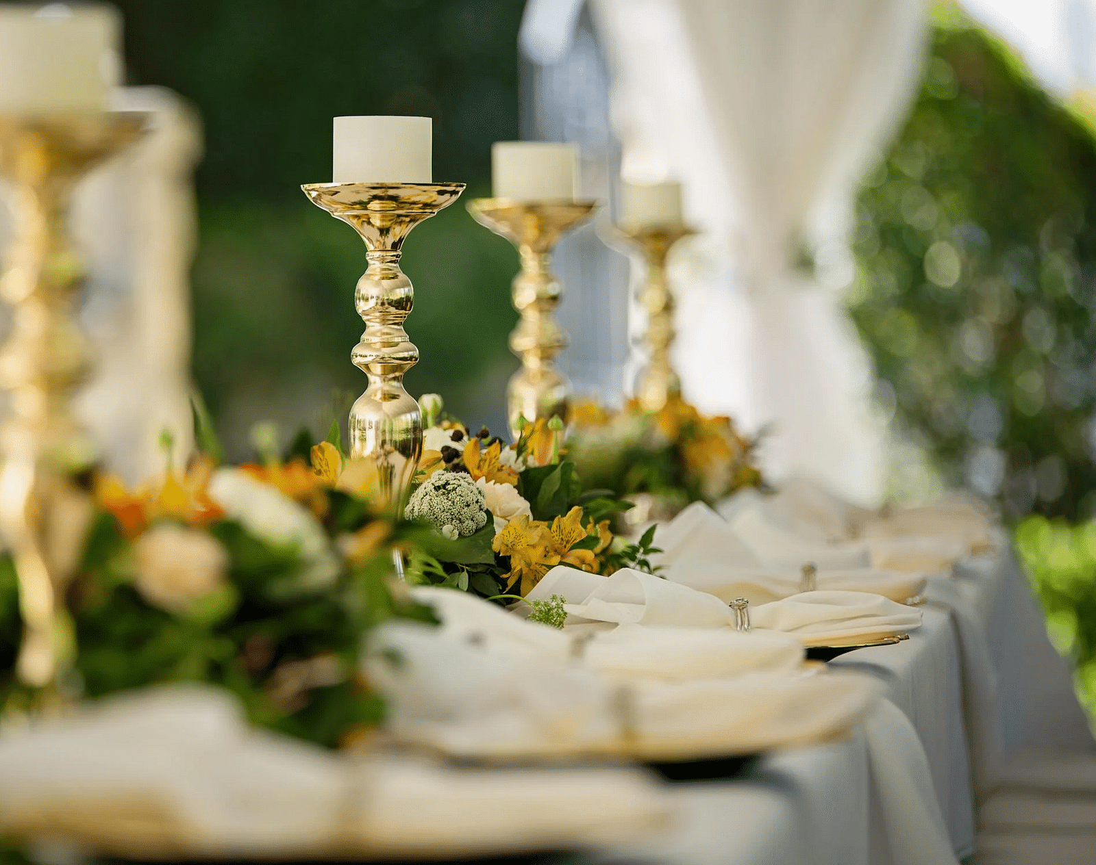 Image of a table with candles and cutlery placed on it.