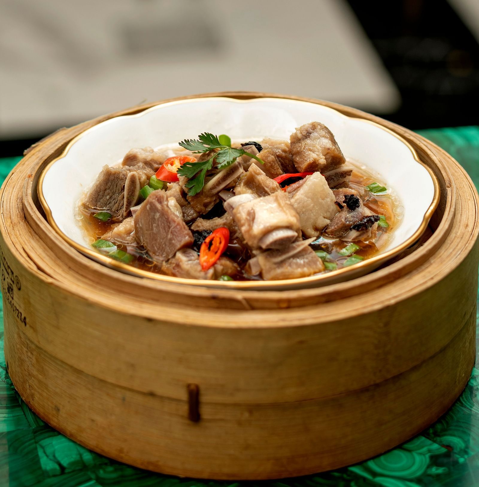 image of a chinese dish made by steaming in the bamboo steamer box at the jade - The Claridges New Delhi