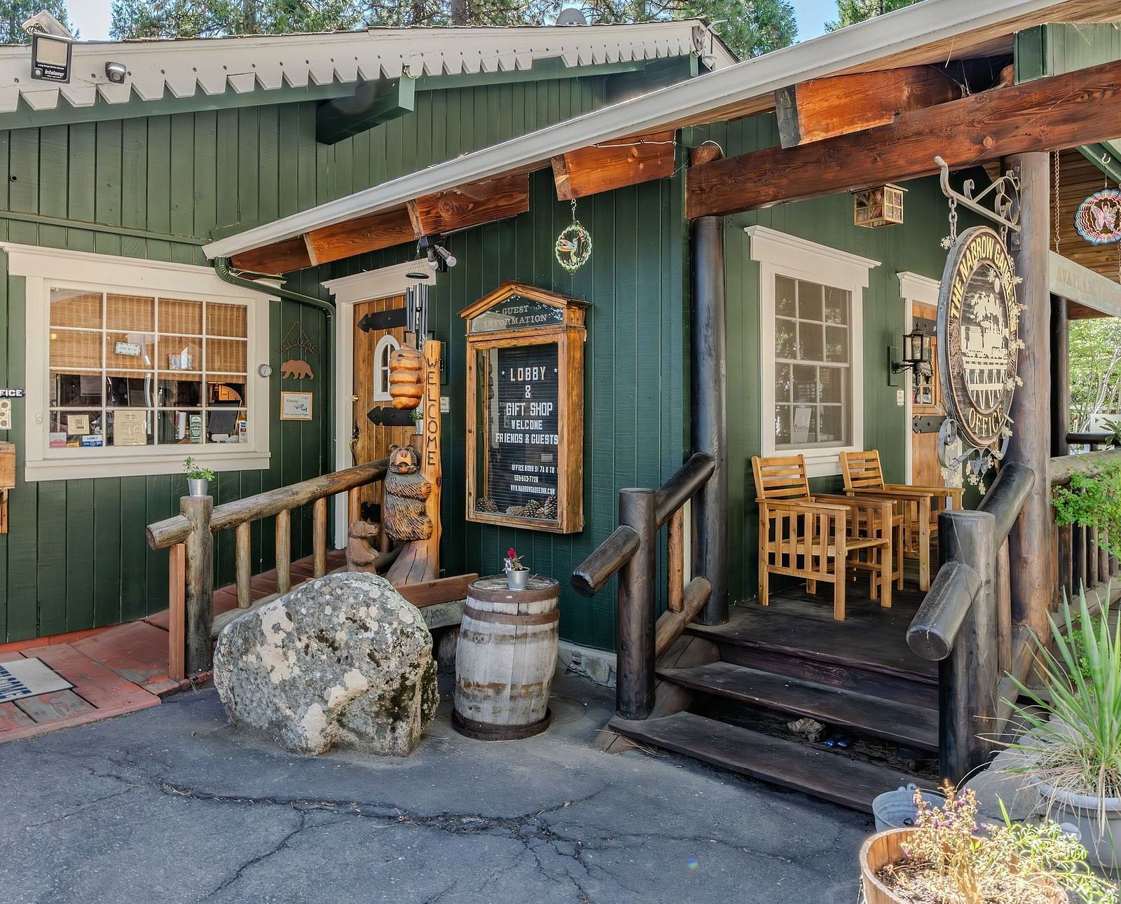 A view of a wooden cabin with pastel green exteriors at Narrow Gauge Inn