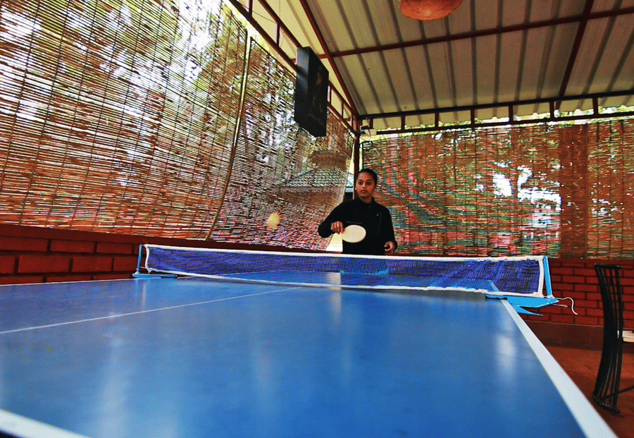 Image of a person playing table tennis at Coorg Jungle Camp Backwater Resort, Kushalnagar.