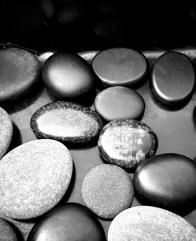 several black and grey colored shinny rocks kept over a black matt serface - Historic Tapoco Lodge