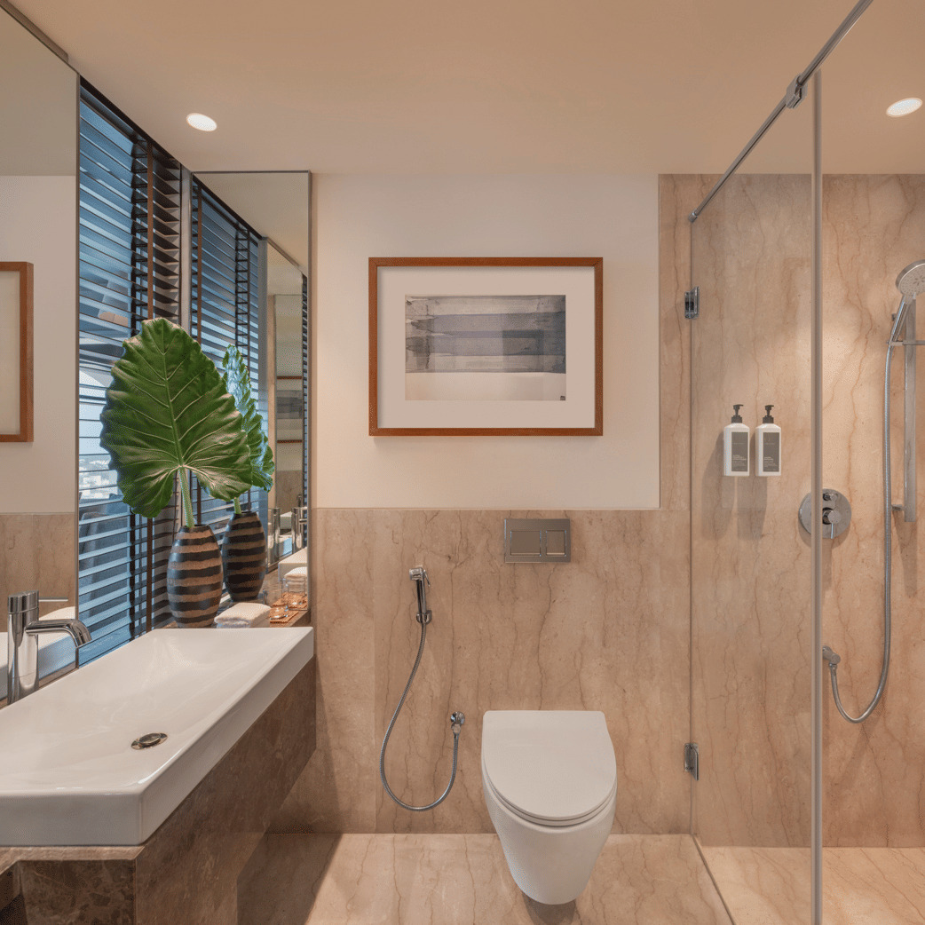 Bathroom with shower area, sink, and mirror at The Raintree, St. Mary’s Road.