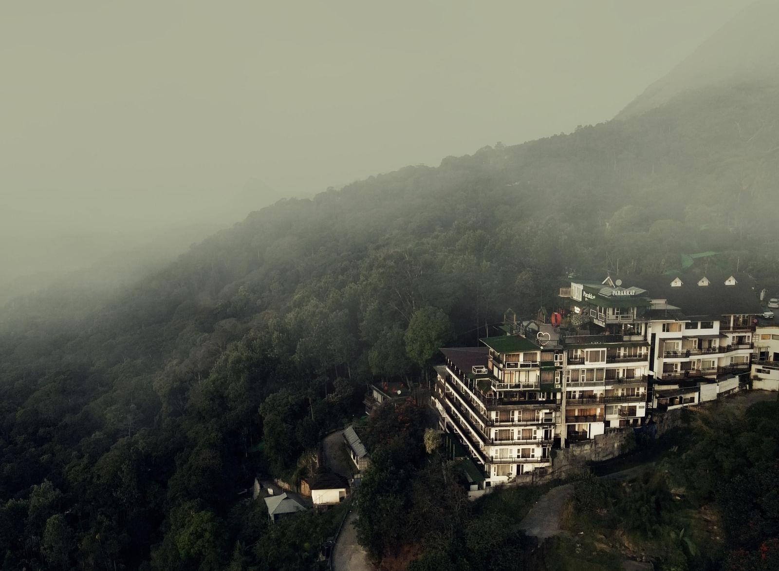 A wider view of the fog surrounding the Facade of Parakkat Nature Hotel and Resorts, Munnar 2