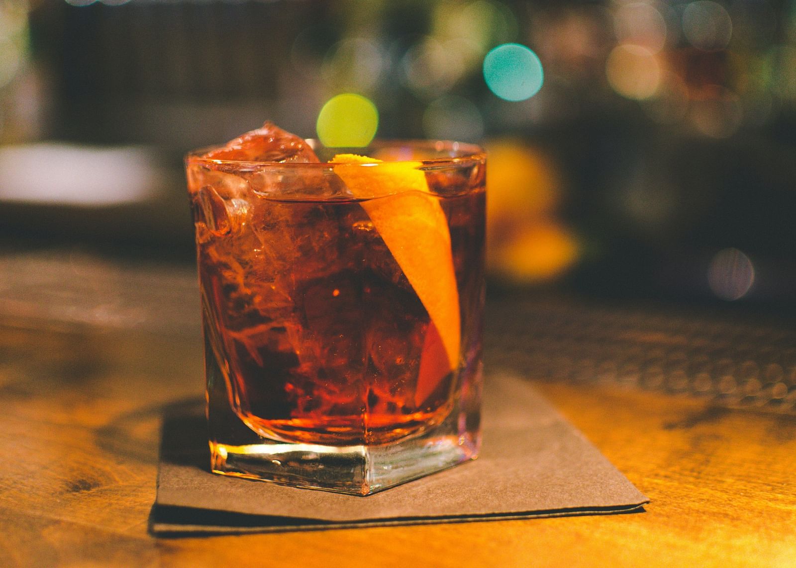 An image of a drink with a slice of a lemon placed on a table in a warm-coloured room - Hotel 39, Jamaica