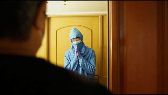 a person wearing a ppe kit and sanitizing the hotel in vile parle 
