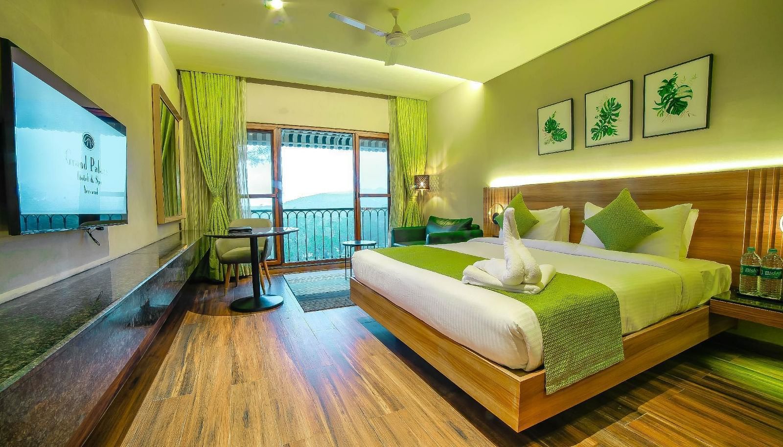 Double bed and balcony in the Deluxe Room at Grand Palace, Yercaud