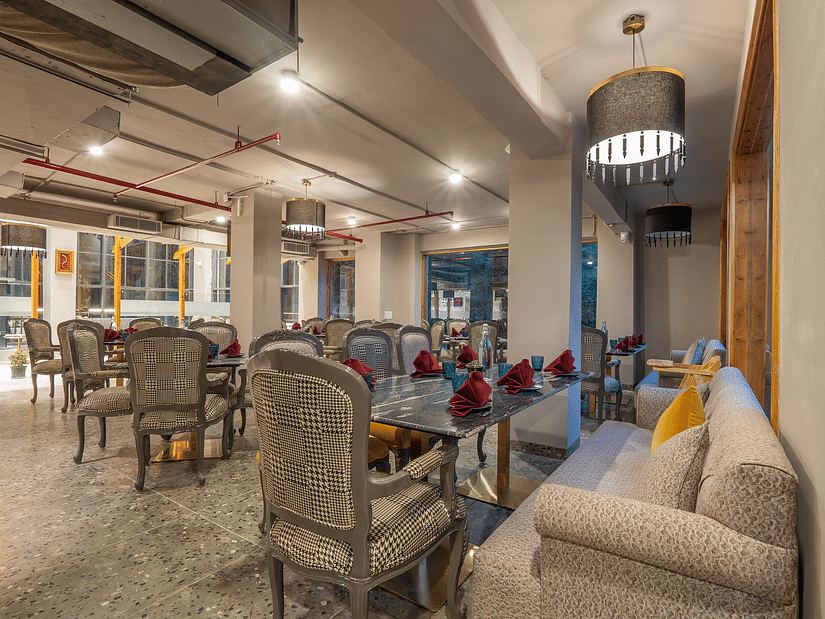an image of a side view of a restaurant with with fancy lights hanging from the ceiling