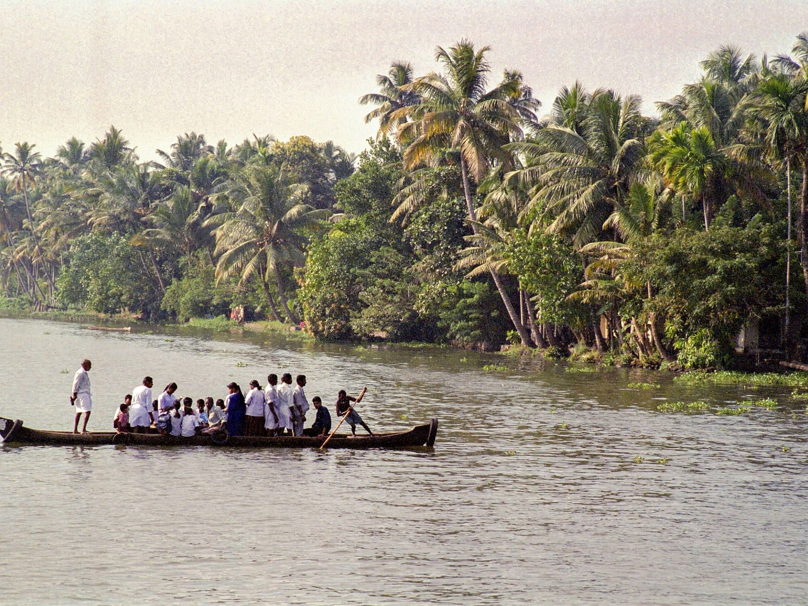 people ride a boat on a river