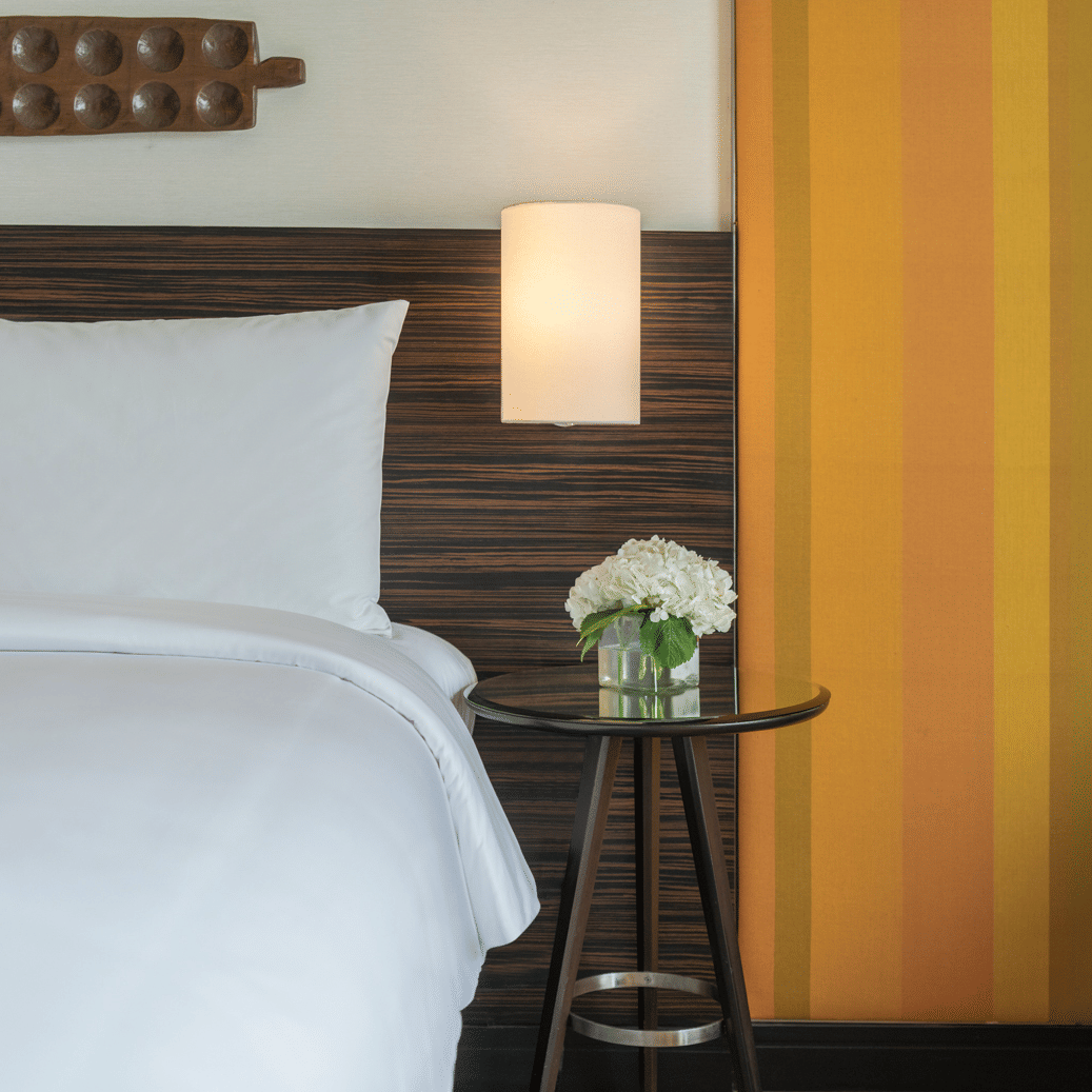 Bedside view with lamp and flower vase at The Raintree, St. Mary’s Road.