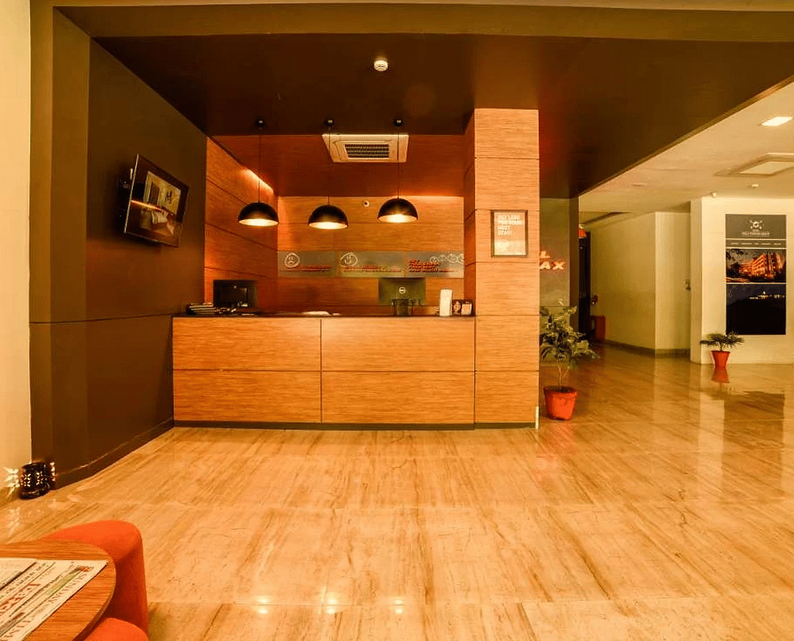 front view image of the reception area of our hotel with a waiting area in front of it - Max Hotel Jabalpur