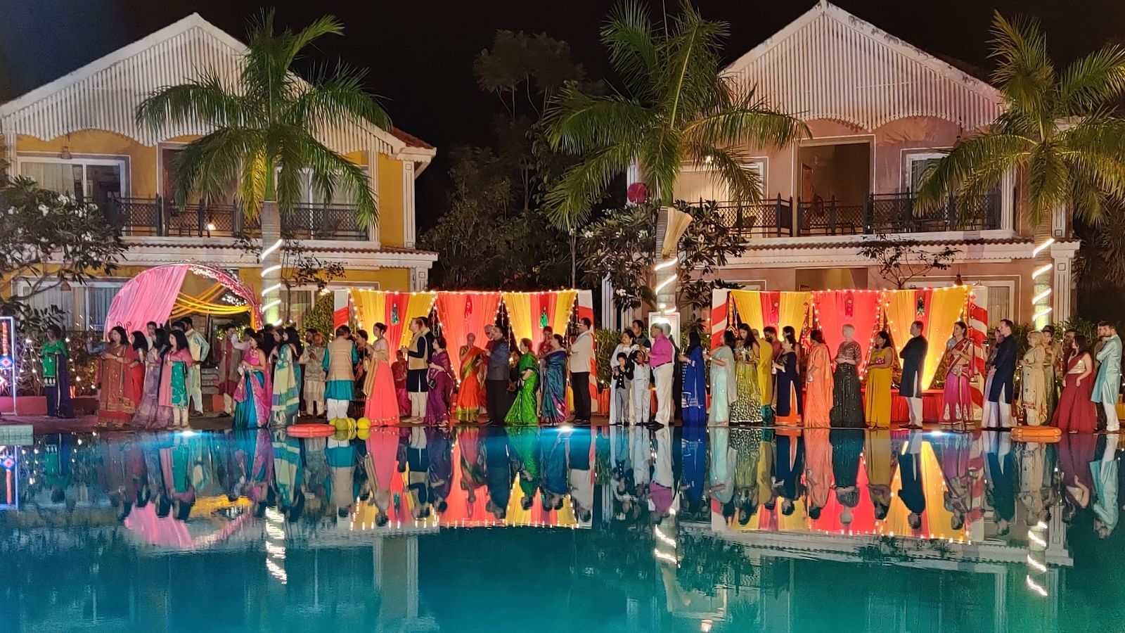 Swosti Chilika Resort - Image of people lined up by the swimming pool in an outdoor banquet space ihrf5v