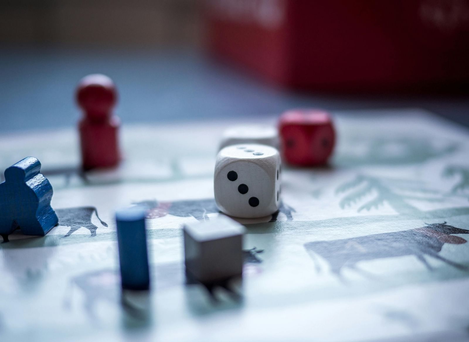 A closeup shot of dice rolled over a game board.