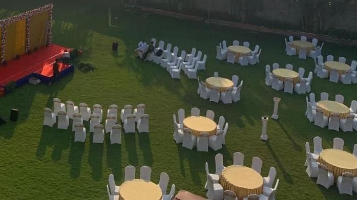 Artistic wedding layout with table arrangements and stage mock-up at Ilara Hotels & Spa, OMR, Chennai