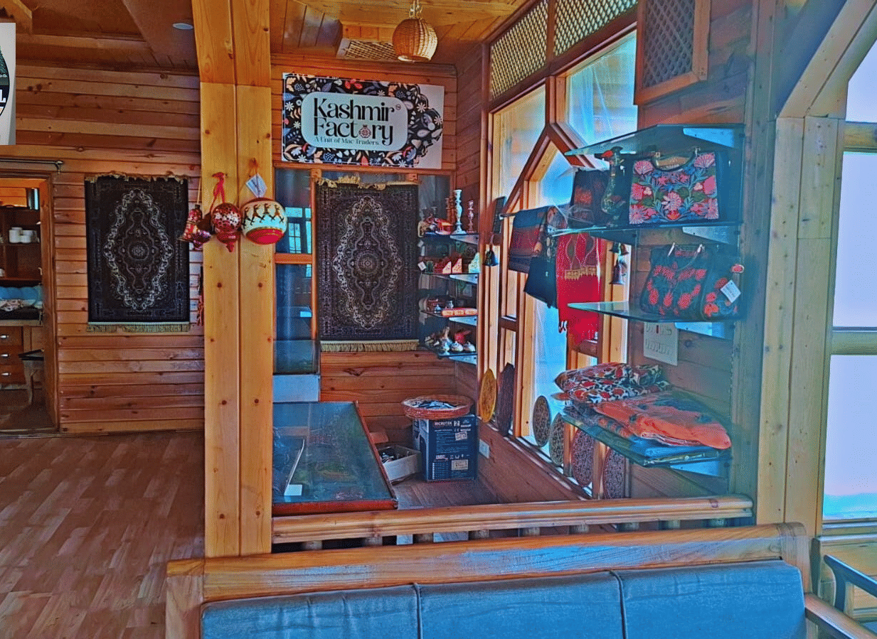 An interior gift shop area at Dawat e Drung by FrozenFall Resort, Drung, Tangmarg, featuring wood panelling, displays and large glass windows.