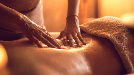 A technician massing their client's back.