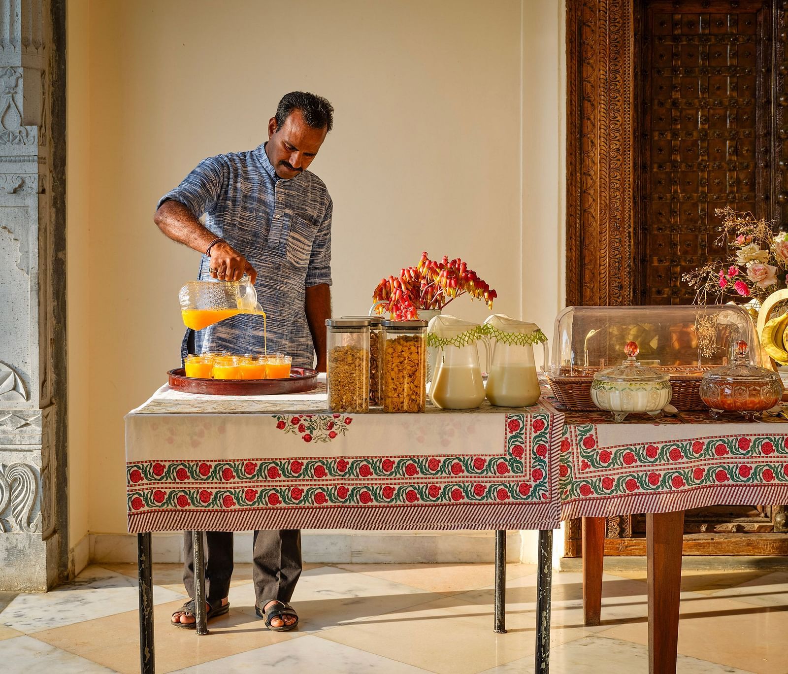 image of a man pouring orange juice at dev shree, deogarh