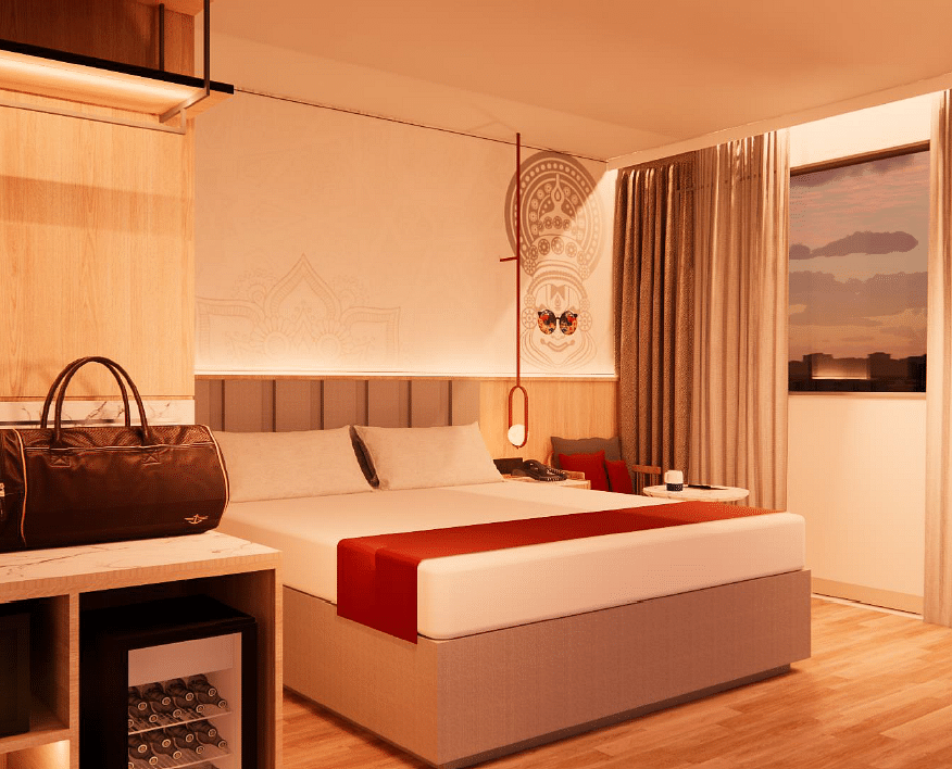 A close up shot of the plush bed in a room with warm lighting at TGI Oberon, Koramangala