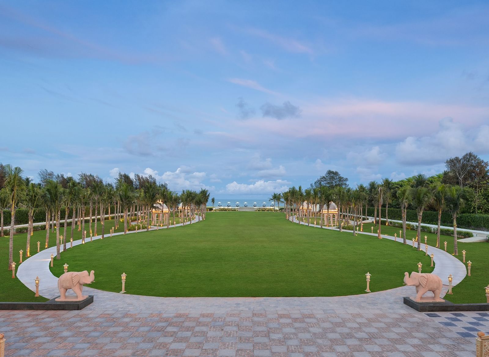 An outdoor lawn in Mahabalipuram surrounded by lush greenery and offering views of the sea – Kaldan Samudra Palace, one of the premier Outdoor Lawn Wedding Venues in ECR