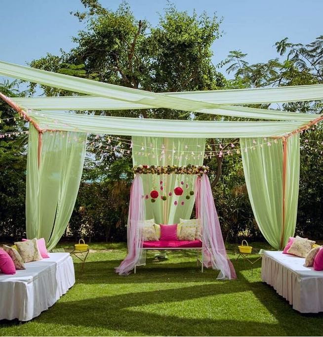 Outdoor seating arrangements for a wedding ceremony in a beautiful open garden.