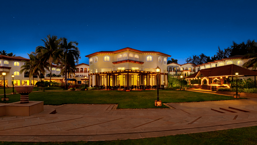 Evening view of Kenilworth Resort & Spa, Goa, showcasing the illuminated resort facade, landscaped grounds, and elegant architecture.