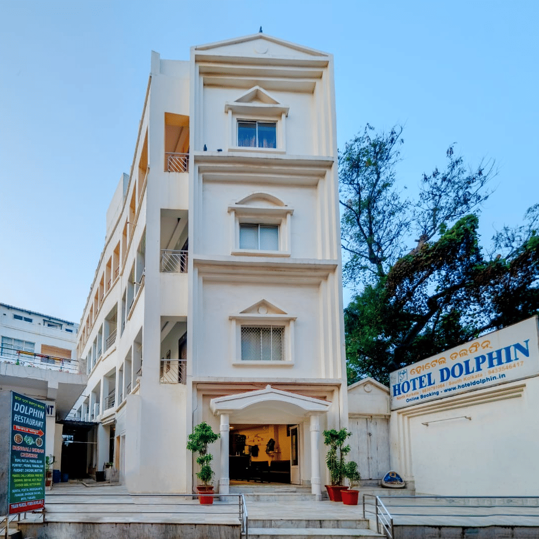 Front facade of Hotel Dolphin Puri with entrance signage and exterior architecture.