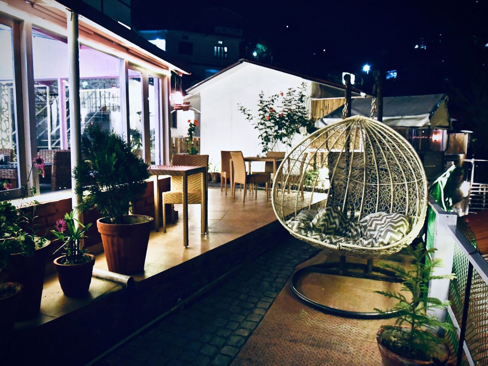 image of a swing with cushions on it at the exterior of the tattva, joshimath during the night