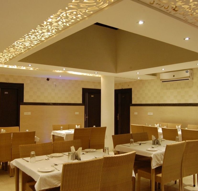 Dining area with arranged seating for guests at Hotel Diamond Plaza, Chandigarh