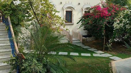 A staircase leading to rooms seen from the lawn of Deramandawa