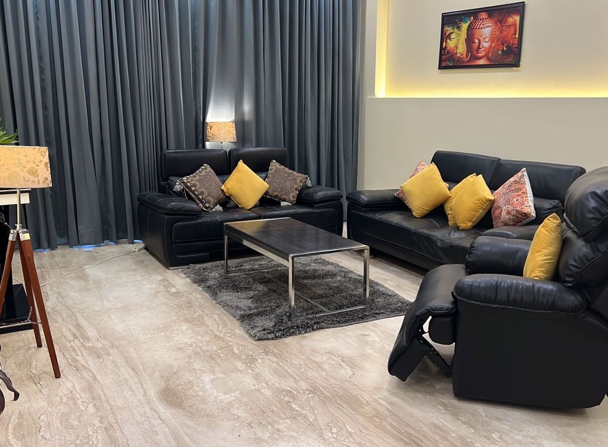 Sofas in front of the TV at Lime Tree 3BHK Serviced Apartments, DLF Phase - 5 Gurgaon