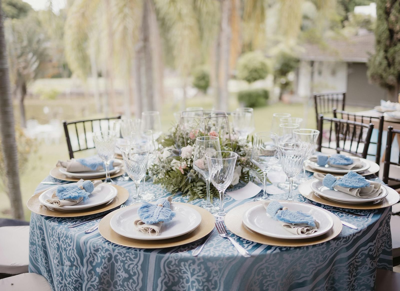 A beautifully arranged table and chairs, adorned for an event.