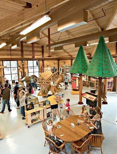 Interiors of a museum with large wooden beams and a sloping roof line - Shaver Lake Village Hotel.