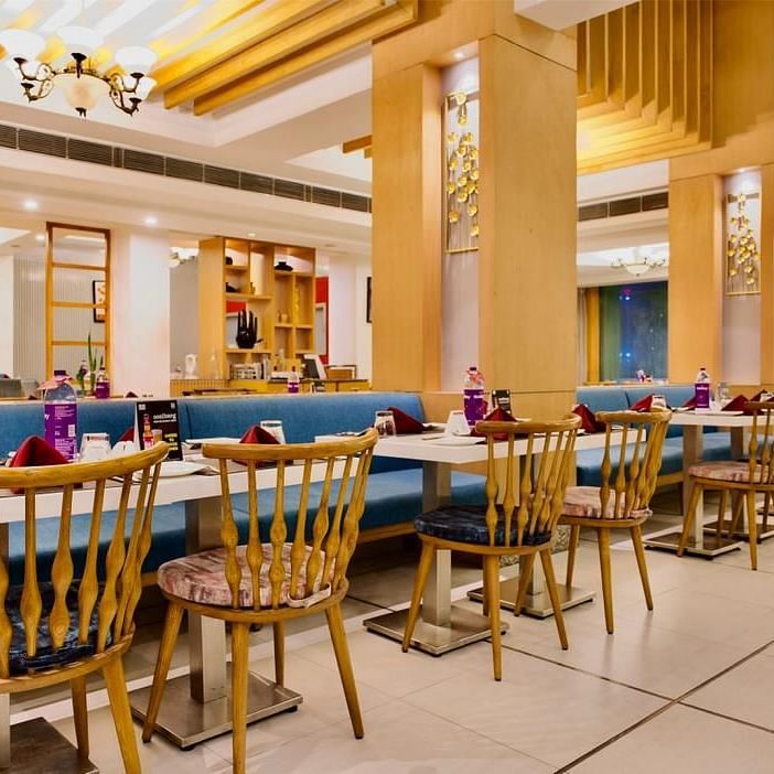 Dining area of Lords Plaza Ankleshwar featuring comfortable seating and modern interiors