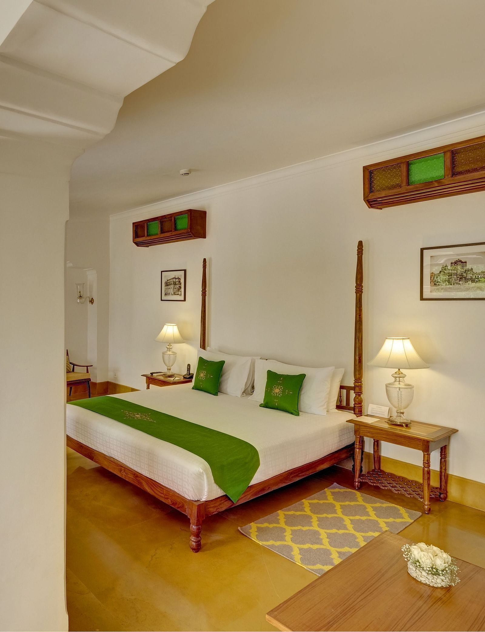 Imperial Suite at Saraca Hotel, Lucknow with a double bed and a large, open living space with arched pillars