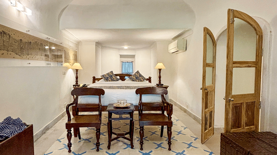 Guest room at Tijara Fort-Palace - 19th Century, Alwar, showcasing historic architecture and regional decor.
