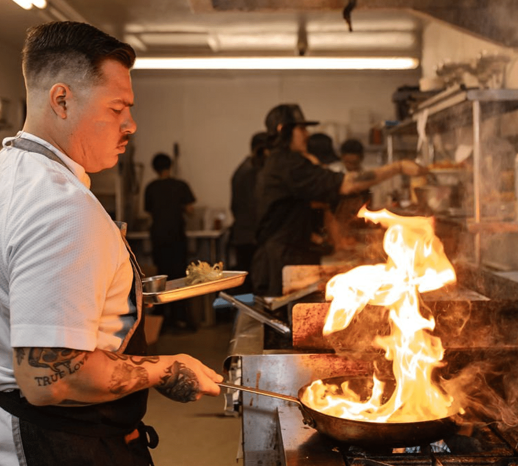 A chef cooking in a commercial kitchen