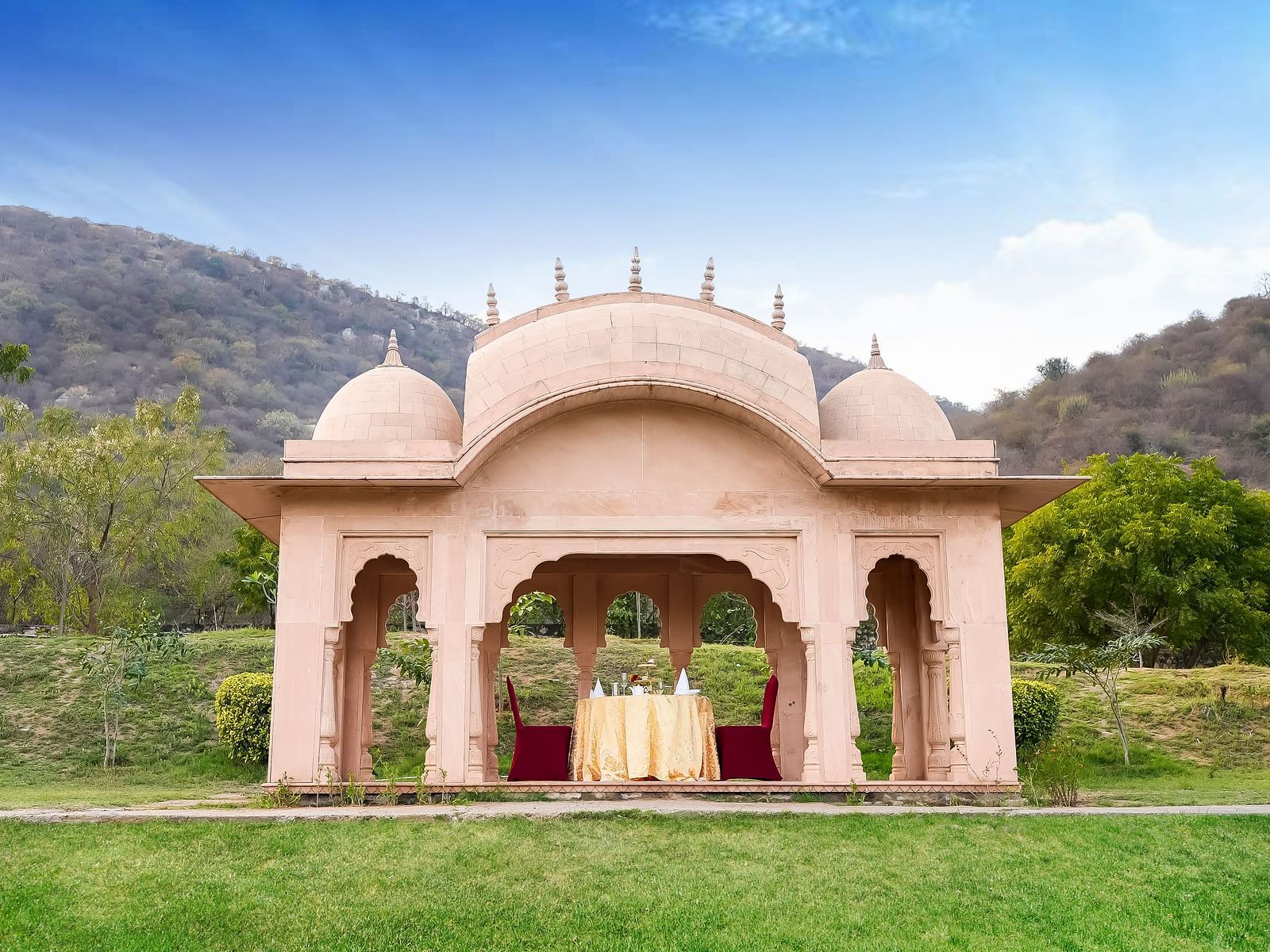 A structure in the middle of a lawn with a table in between - Rajasthali Resort & Spa, Jaipur.
