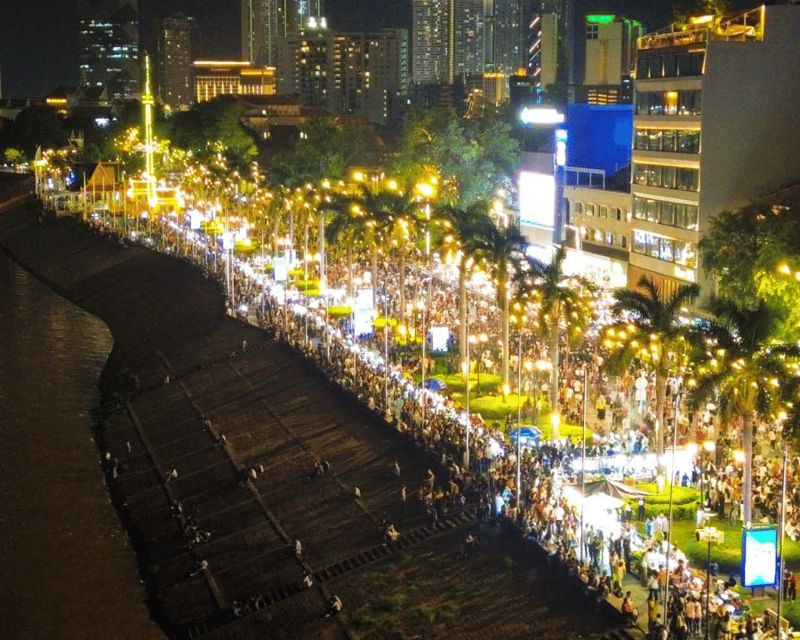 Vibrant night view of Chaktomuk Walk Street along the Riverside, popular for evening strolls near Central Mansions.