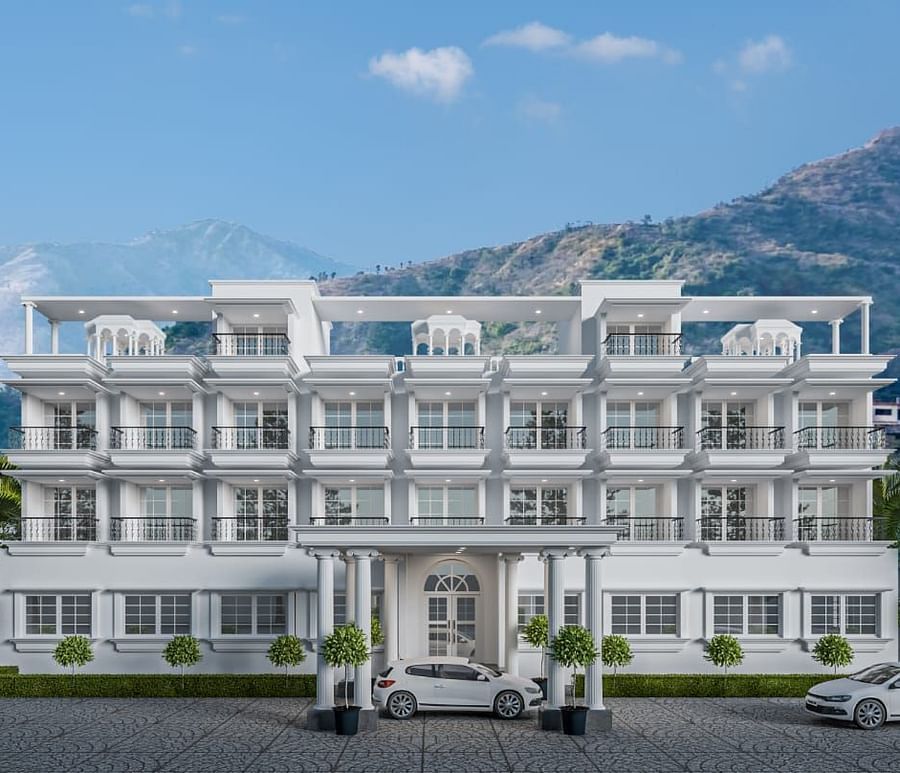 Front view shot of the facade of Namaste Corbett with beautiful mountains in the background.