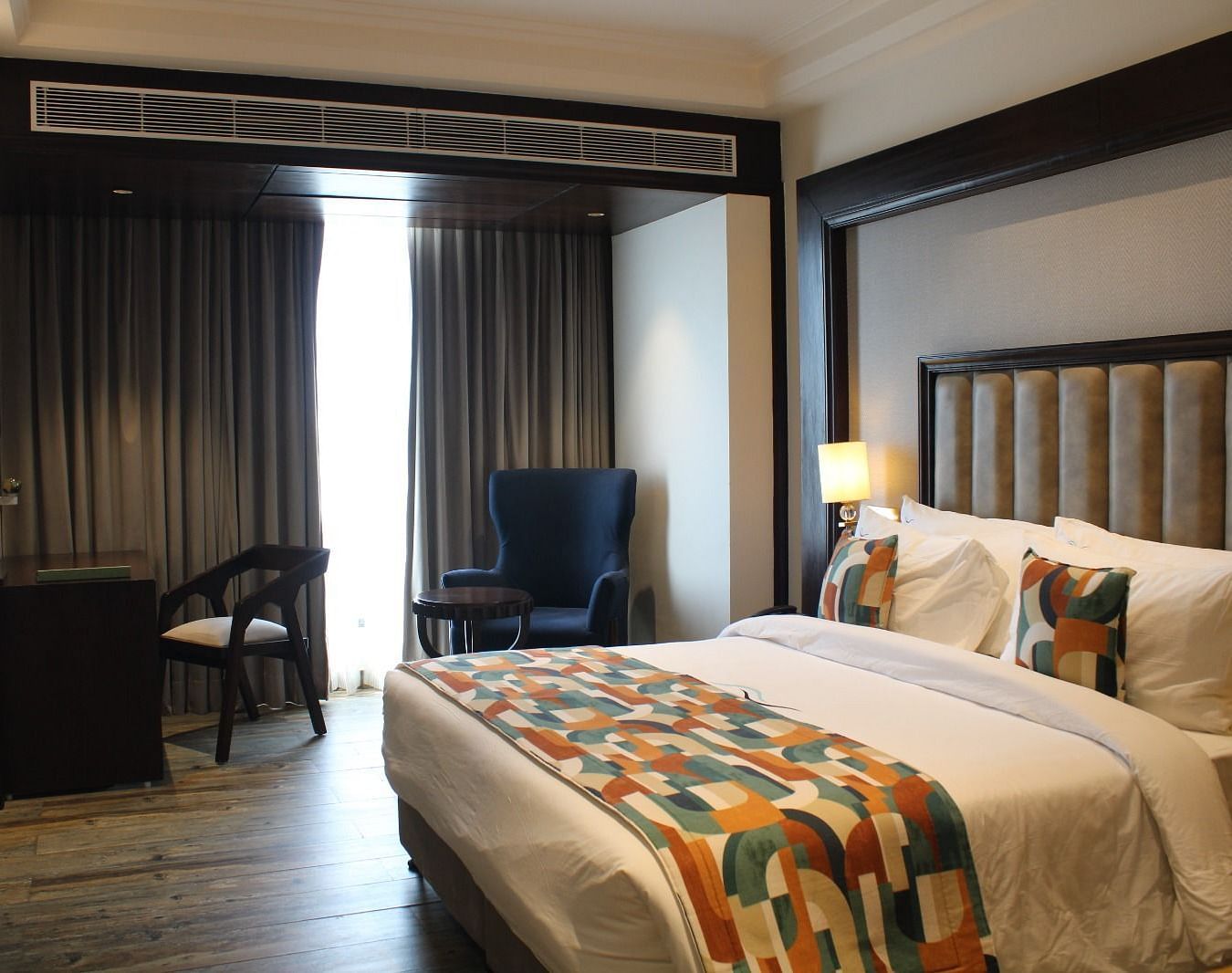 A bedroom with a window draped in curtains at BluSalzz Residence, Amritsar