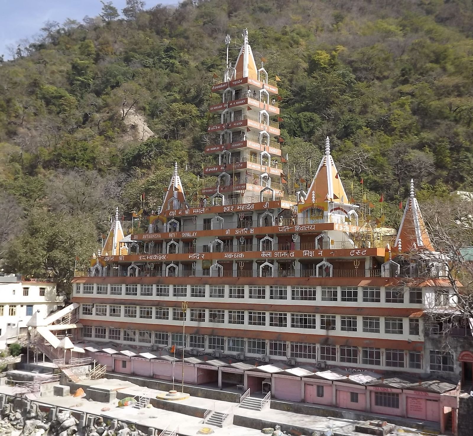 image featuring the exterior image of a monastery with a lush green trees in the background